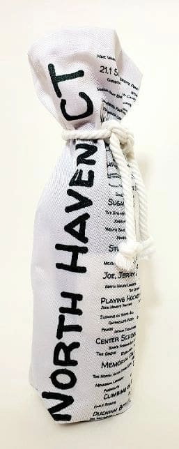 A white bottle bag with the name of a person on it.