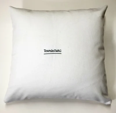 A white pillow with the words " theraputic " written on it.