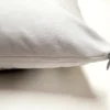 A pillow with a white cover on it