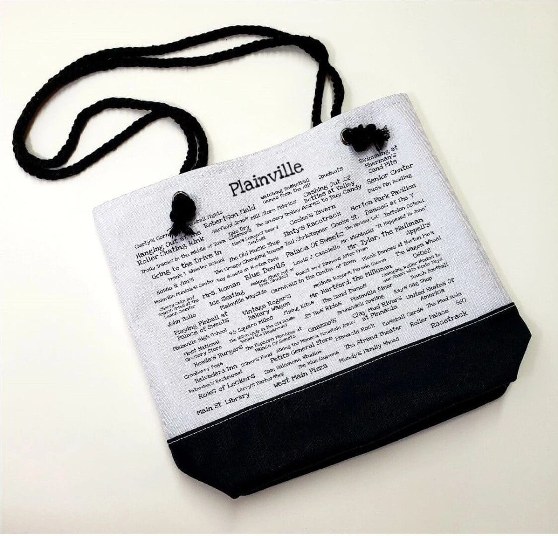 A bag with a black cord and white paper.