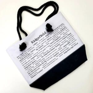 A bag with a black handle and some white writing