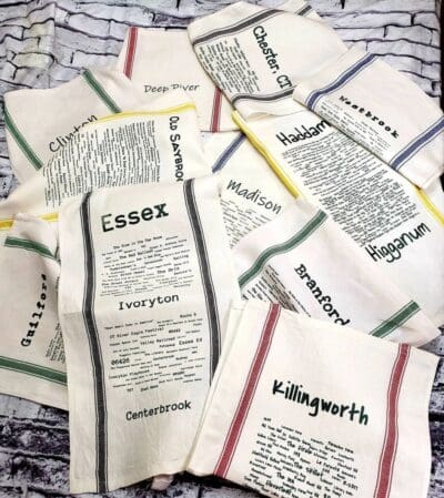 A bunch of tea towels with different words on them