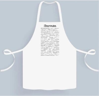 A white apron with the word " derriere " written on it.