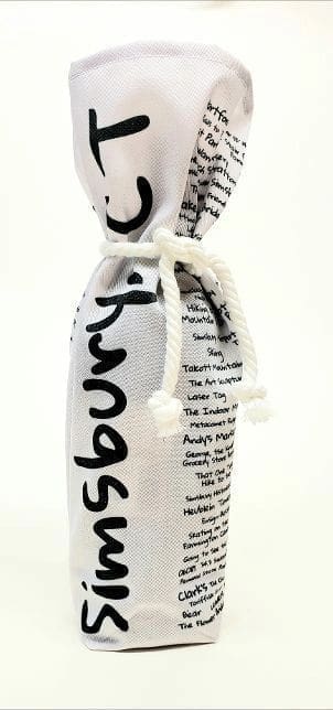 A bottle of wine wrapped in newspaper with string.