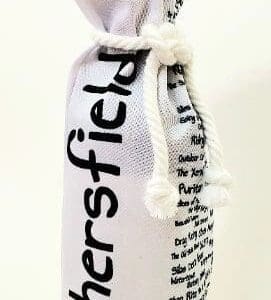 A bottle of wine is wrapped in a white bag.