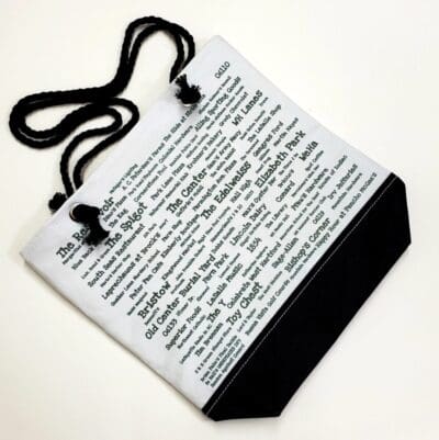 A bag with a black strap and white pages.