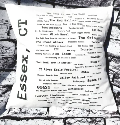 A pillow with the words essex, ct written in black and white.