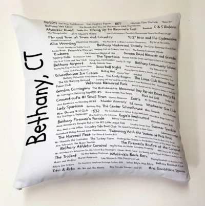 A pillow with the names of many people in it.