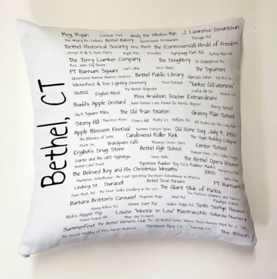 A pillow with the names of people in it.