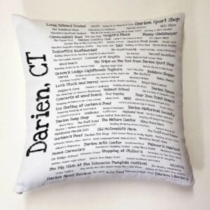 A pillow with the name darien, ct written on it.