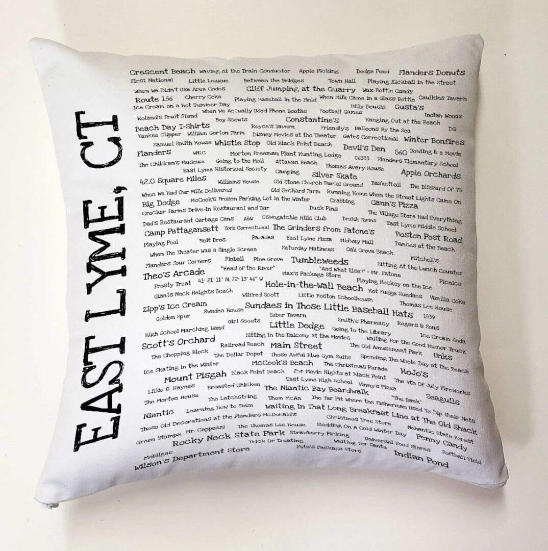 A white pillow with black writing on it.