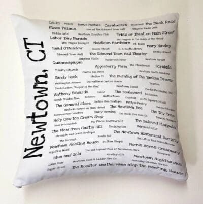 A pillow with the words newtown, ct written on it.