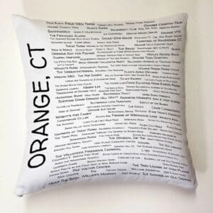 A pillow with the words orange, ct written on it.