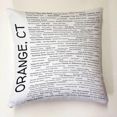 A pillow with the words orange, ct written on it.