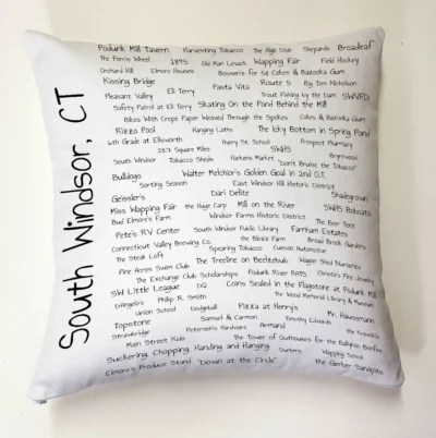 A pillow with the names of many different places.