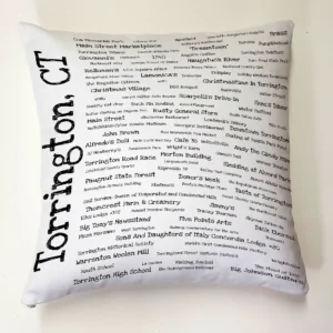 A white pillow with black writing on it.