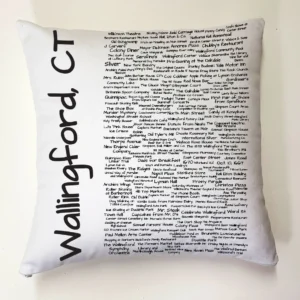 A pillow with words written in black ink.