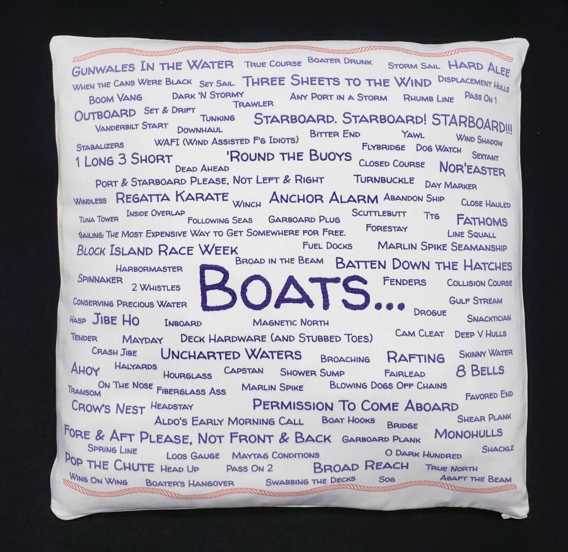 A pillow with the word boats written all over it.