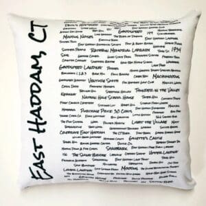 A white pillow with black writing on it.