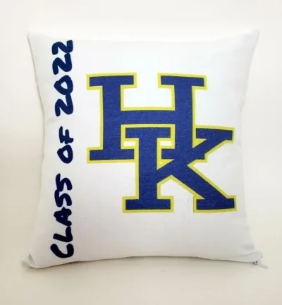 A pillow with the letters h and k on it.