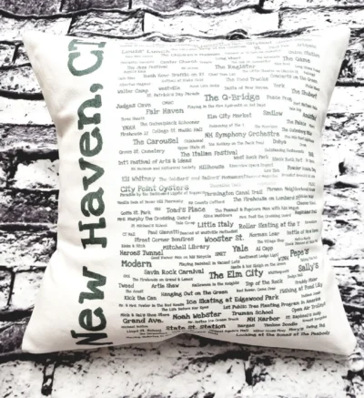 A pillow with the words " new haven, ct." written on it.