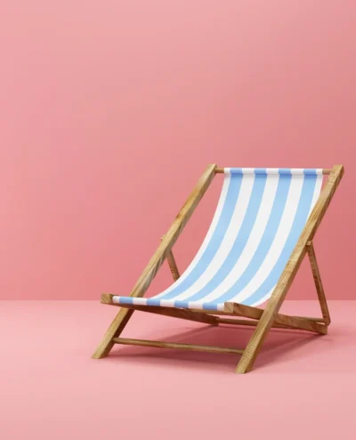 A blue and white striped chair on pink floor