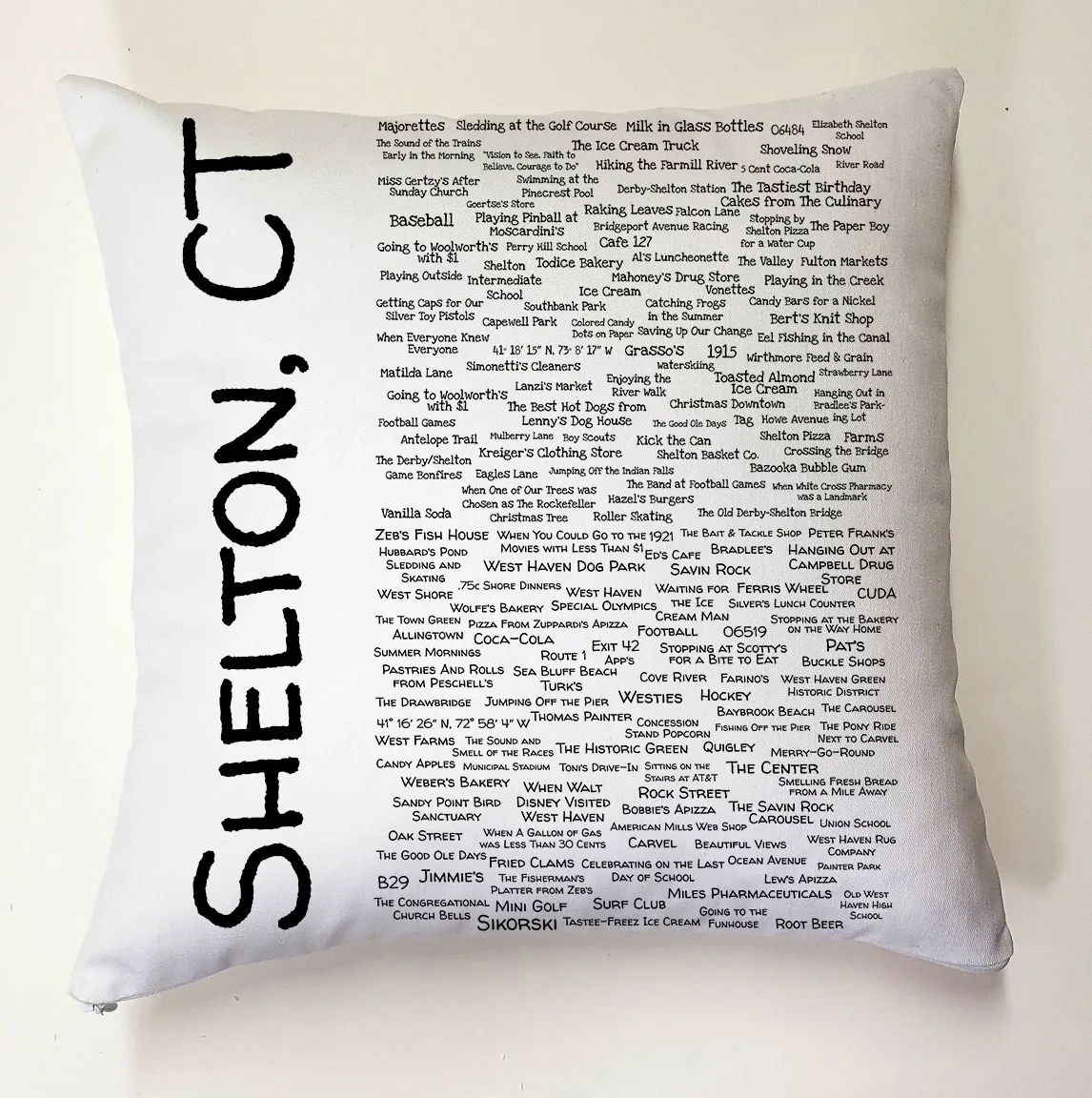 A pillow with the names of all the places in shelton, ct.