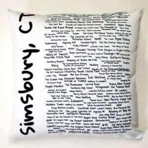 A white pillow with black writing on it.