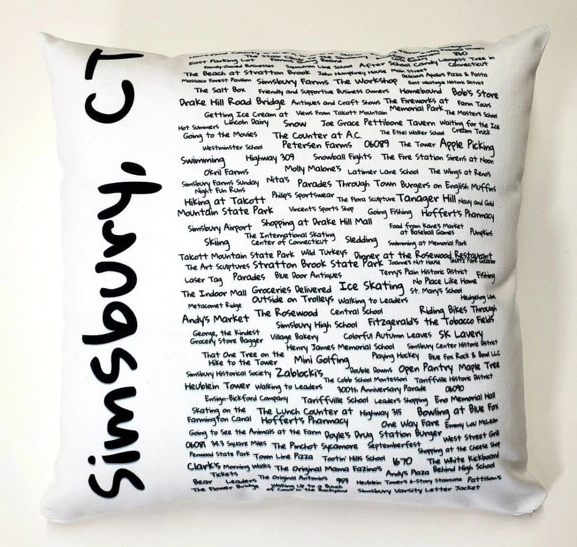 A white pillow with black writing on it.