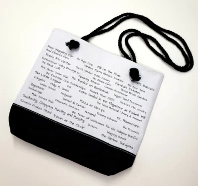 A white and black bag with words written on it.