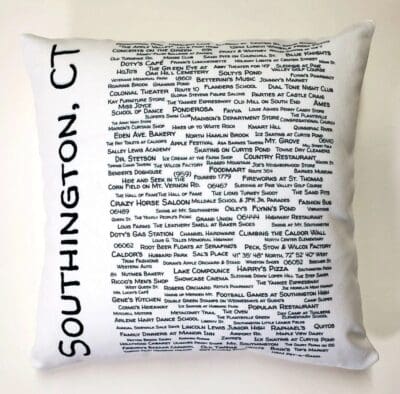 A white pillow with black writing on it.