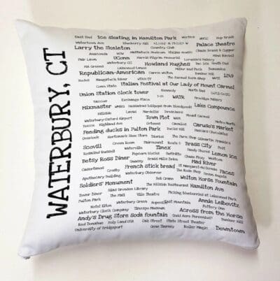 A white pillow with many words written on it.