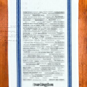 A blue striped towel with trivia about Burlington, Vermont