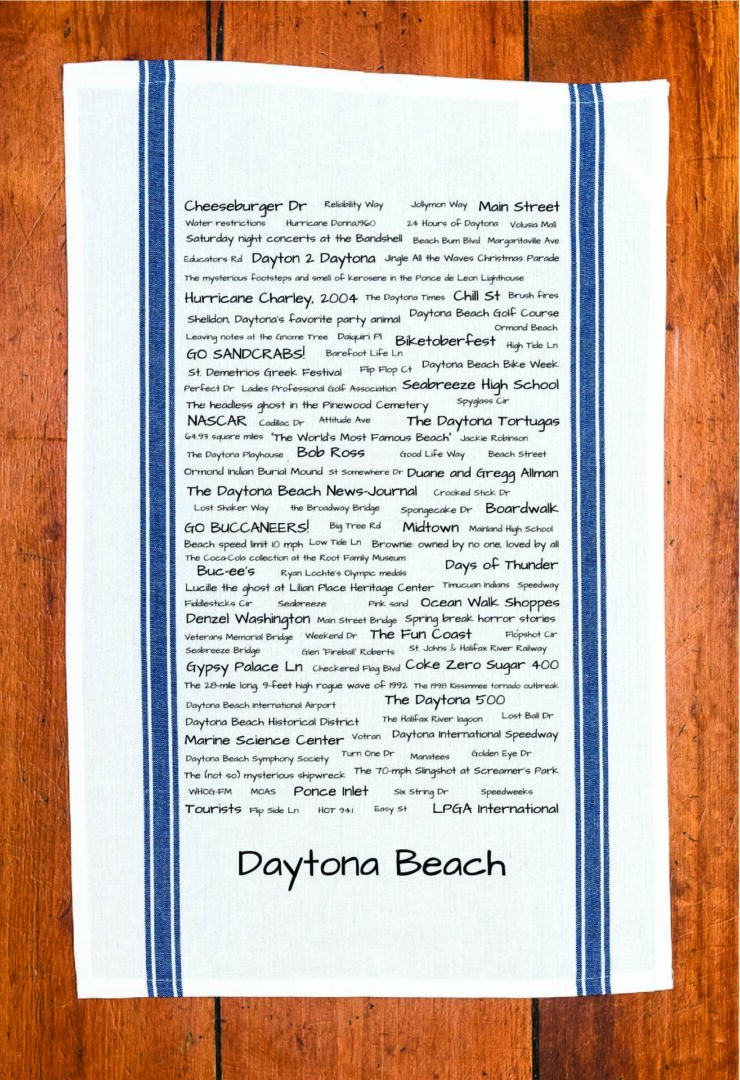 A blue striped towel with trivia about Daytona Beach, Florida
